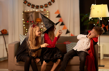 Image showing kids in halloween costumes playing at home