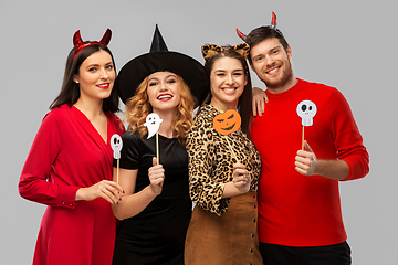 Image showing friends in halloween costumes with party props