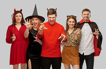 Image showing friends in halloween costumes scaring