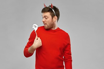 Image showing happy man in halloween costume of devil over grey