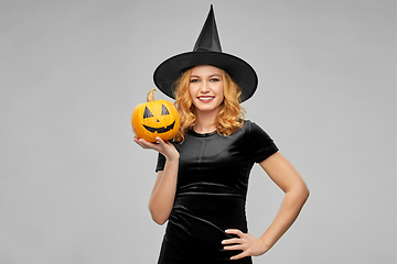 Image showing woman in halloween costume of witch with pumpkin