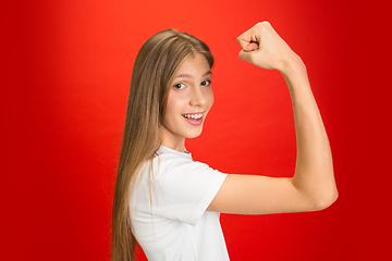 Image showing Portrait of young caucasian woman with bright emotions on bright red studio background