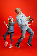 Image showing Senior man, grandfather having fun and spending time together with girl, granddaughter. Joyful elderly lifestyle concept