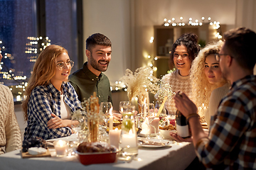 Image showing happy friends with red wine at christmas party