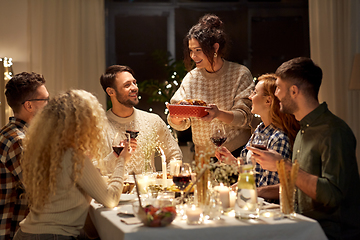 Image showing happy friends having christmas dinner at home