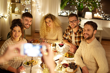 Image showing friends photographing at christmas dinner party