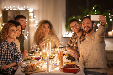 Image showing friends taking selfie at christmas dinner party