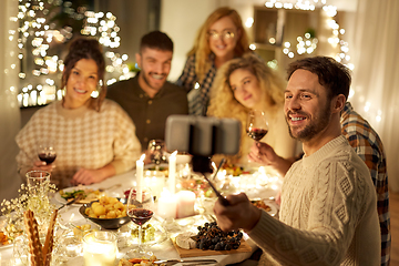 Image showing friends taking selfie at christmas dinner party