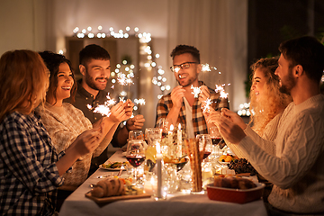 Image showing happy friends having christmas dinner at home