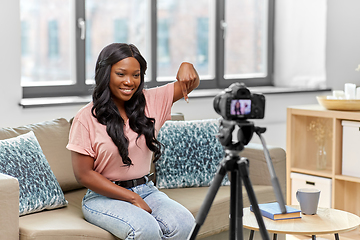 Image showing female blogger with camera video blogging at home