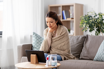 Image showing sick woman having video call on tablet pc at home