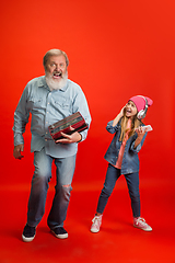 Image showing Senior man, grandfather having fun and spending time together with girl, granddaughter. Joyful elderly lifestyle concept