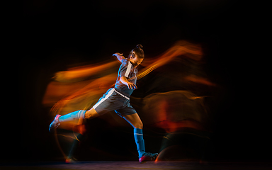 Image showing Football or soccer player on black background in mixed light, fire shadows