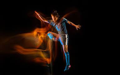 Image showing Football or soccer player on black background in mixed light, fire shadows