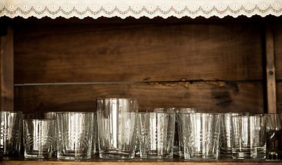 Image showing glasses on the shelf of an old cabinet