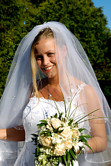 Image showing Happy smiling wedding bride with bouquet.