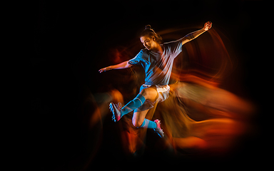 Image showing Football or soccer player on black background in mixed light, fire shadows