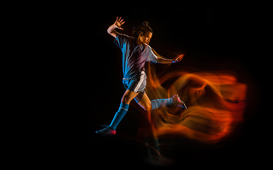 Image showing Football or soccer player on black background in mixed light, fire shadows