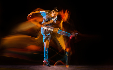 Image showing Football or soccer player on black background in mixed light, fire shadows