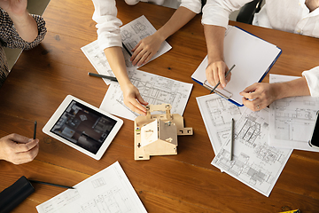 Image showing Male architect-engineer presents project of future house for young family.