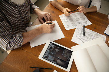 Image showing Male architect-engineer presents project of future house for young family.