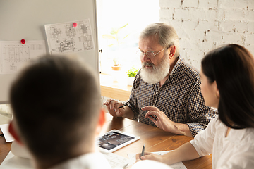 Image showing Male architect-engineer presents project of future house for young family.