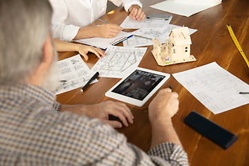 Image showing Male architect-engineer presents project of future house for young family.