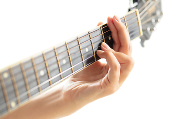 Image showing Close up of guitarist hand playing guitar, copyspace, macro shot