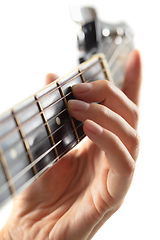 Image showing Close up of guitarist hand playing guitar, copyspace, macro shot