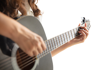 Image showing Close up of guitarist hand playing guitar, copyspace, macro shot