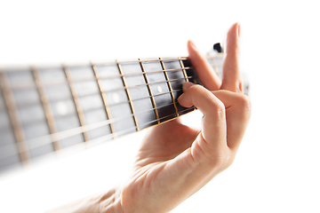 Image showing Close up of guitarist hand playing guitar, copyspace, macro shot