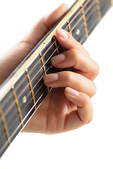 Image showing Close up of guitarist hand playing guitar, copyspace, macro shot