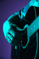 Image showing Close up of guitarist hand playing guitar, copyspace, macro shot