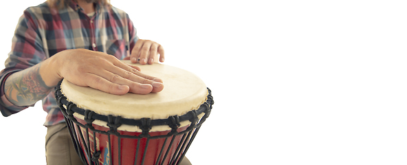 Image showing Man plays ethnic drum darbuka percussion, close up musician isolated on white studio background