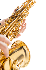 Image showing Close up woman playing saxophone isolated on white studio background