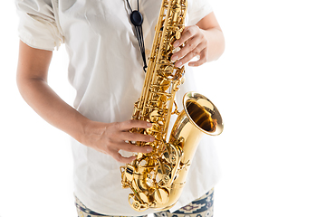 Image showing Close up woman playing saxophone isolated on white studio background