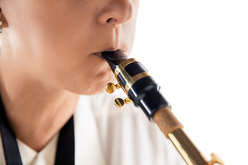 Image showing Close up woman playing saxophone isolated on white studio background