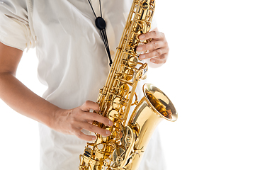 Image showing Close up woman playing saxophone isolated on white studio background