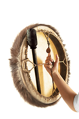 Image showing A close up of hands playing the tambourine, percussion on white studio background