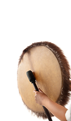 Image showing A close up of hands playing the tambourine, percussion on white studio background