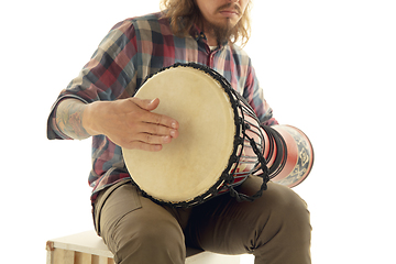 Image showing Man plays ethnic drum darbuka percussion, close up musician isolated on white studio background