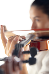 Image showing Close up woman playing violin isolated on white studio background