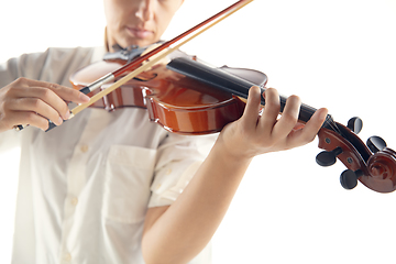 Image showing Close up woman playing violin isolated on white studio background