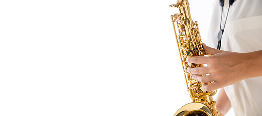 Image showing Close up woman playing saxophone isolated on white studio background