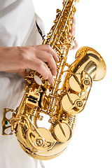 Image showing Close up woman playing saxophone isolated on white studio background