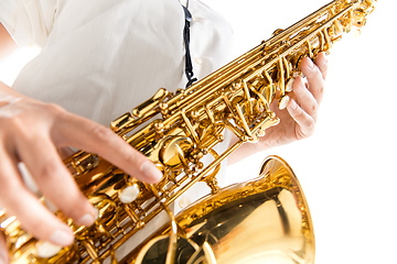 Image showing Close up woman playing saxophone isolated on white studio background