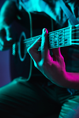 Image showing Close up of guitarist hand playing guitar, copyspace, macro shot