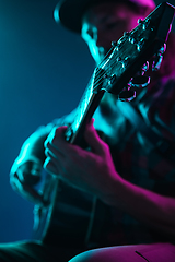 Image showing Close up of guitarist hand playing guitar, copyspace, macro shot