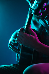 Image showing Close up of guitarist hand playing guitar, copyspace, macro shot