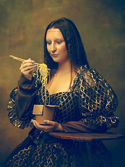 Image showing Young woman as Mona Lisa on dark background. Retro style, comparison of eras concept.